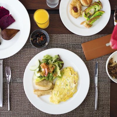 Fruit, eggs, cereal and pastry breakfast.