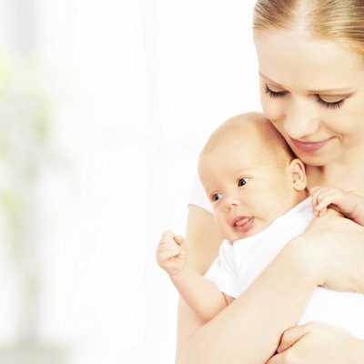 newborn baby in the arms of mother