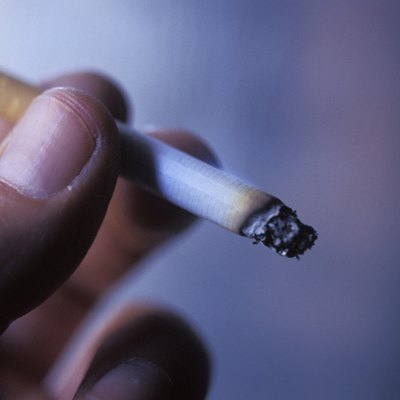 Hand Holding Burning Cigarette