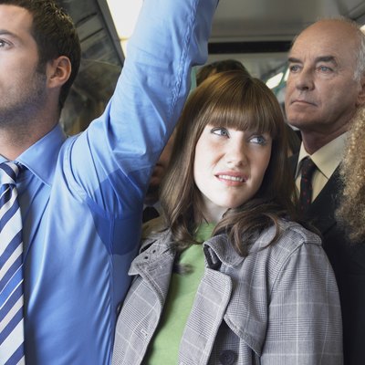 Female Commuter Standing by Man's Wet Armpit In Train