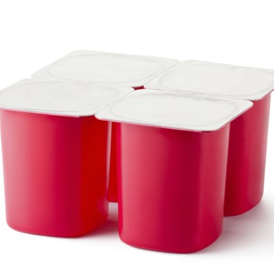 Four plastic containers for dairy products with foil lid