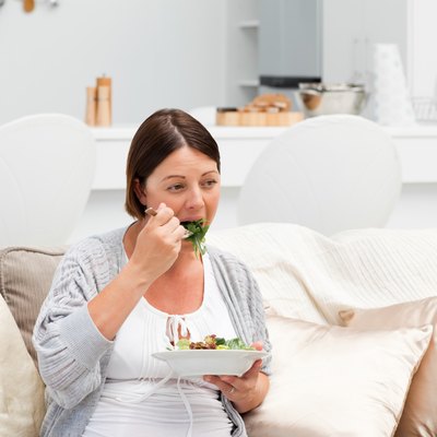 Pregnant woman eating vegetables