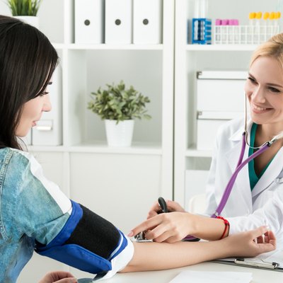 Medicine doctor measuring blood pressure to patient