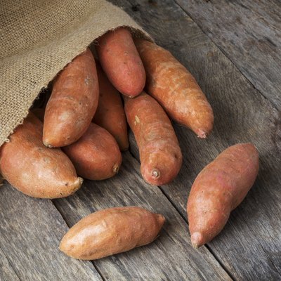 Sweet Potatoes Spilling From Burlap Bag