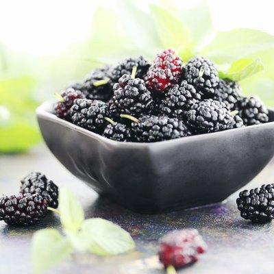 juicy mulberry on a black plate