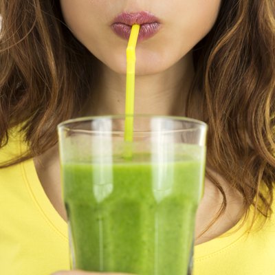 Woman drinking green smoothie