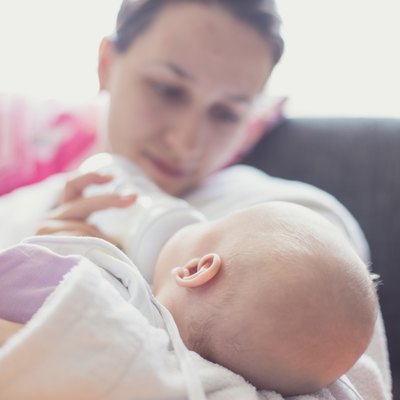 Mother feeding her newborn baby girl