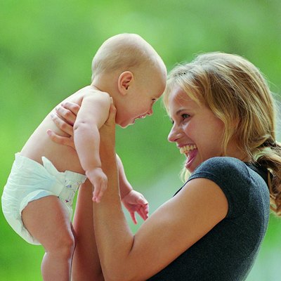 Side view of mother laughing with baby