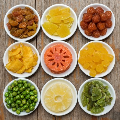 Collection dried fruits on a row of ceramic bowl
