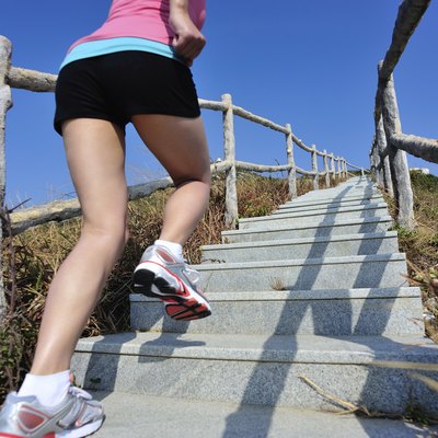 woman running up on mountain stairs