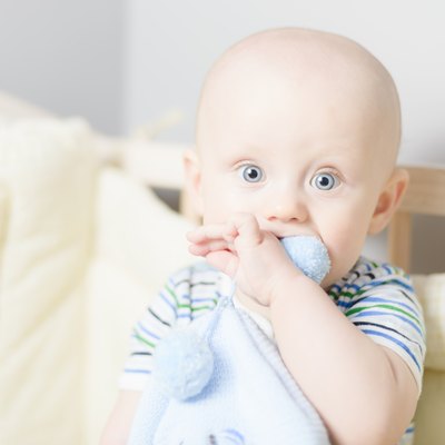 baby playing when sitting in crib