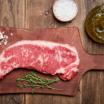 Raw beef meat Ribeye Steak with herbs and spices