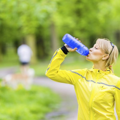 Female runner drinking water
