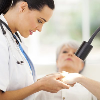 dermatologist examining senior woman's skin