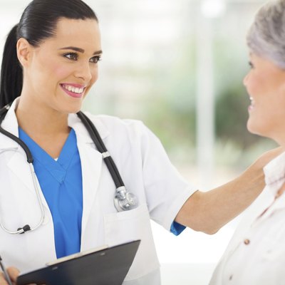 female doctor comforting middle aged patient