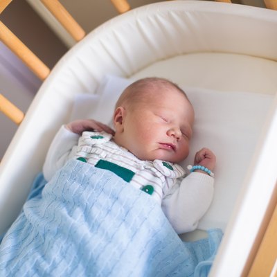Newborn baby boy in hosptal cot