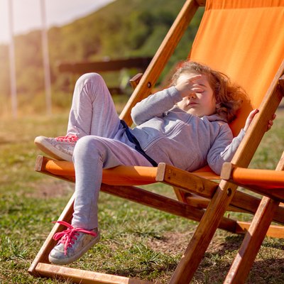 Little girl on a deck chair