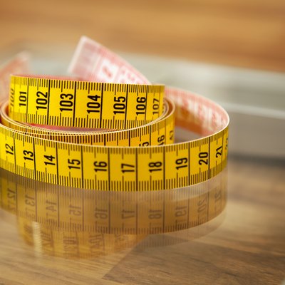 Measuring tape on weight scale.
