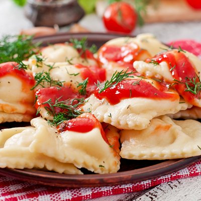 Delicious ravioli with tomato sauce and dill