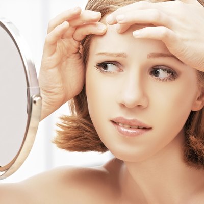 beautiful healthy woman frightened saw in the mirror acne