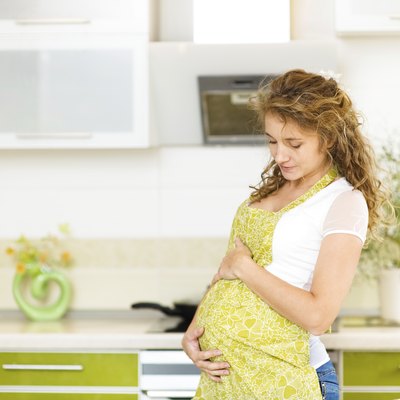 pregnant woman at home in kitchen