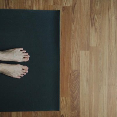 Feet on yoga mat, doing yoga at home, taken with mobile phone