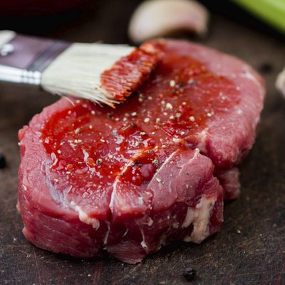 Raw beef steak, greased tomato sauce brush, cooking delicious