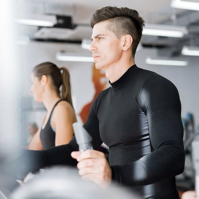 Young group of people working out on a elliptic trainer