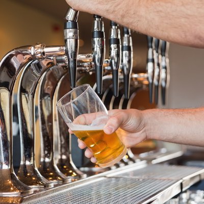 Mans hand pouring beer
