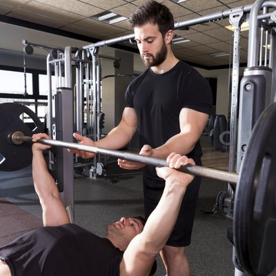 Bench press weightlifting man with personal trainer