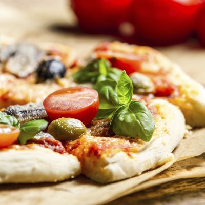 Close-up of freshly baked pizza with tomatoes and olives