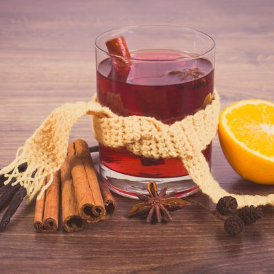 Glass of mulled wine wrapped scarf with fresh fragrant spices