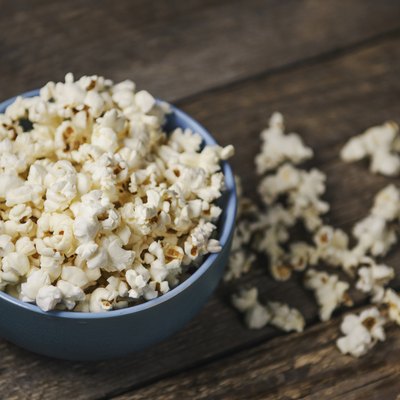 Popcorn in a bowl on wooden table