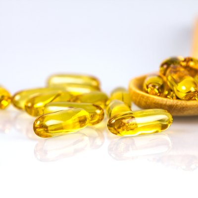 Closeup yellow soft gelatin supplement fish oil capsule