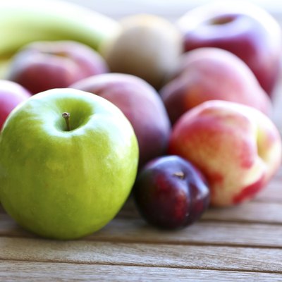 Juicy fruits on wooden table, close-up