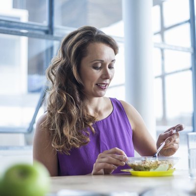 Mid adult woman eating lunch