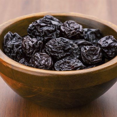 prunes group in wooden bowl