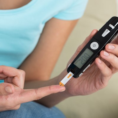 Woman Checking Blood Sugar Level