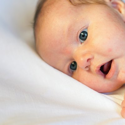Newborn baby lying on a white background