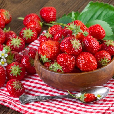 Fresh strawberry on red checkered tablecloth