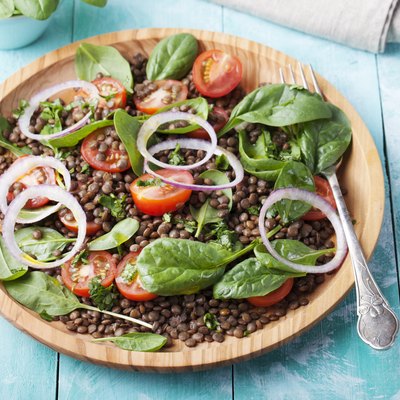 Lentil salad with cherry tomatoes, red onion and baby spinach.