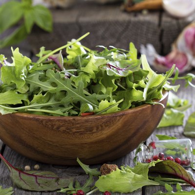 Green salad leaves in a wooden bowl