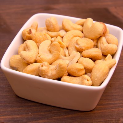 Cashew nuts on bowl on wood