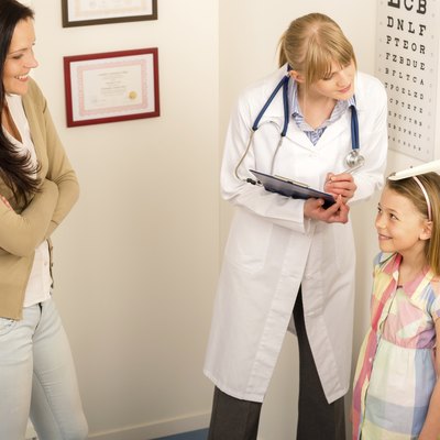 Medical check-up at pediatrist girl measure height