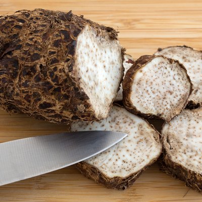 Cut Malanga on a wood cutting board with knife
