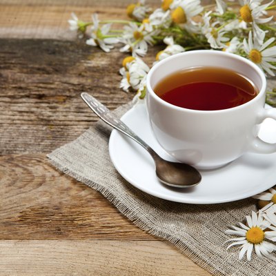 herbal tea with chamomile on old wooden table