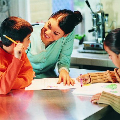Mother Assisting Her Children With Homework in a Kitchen