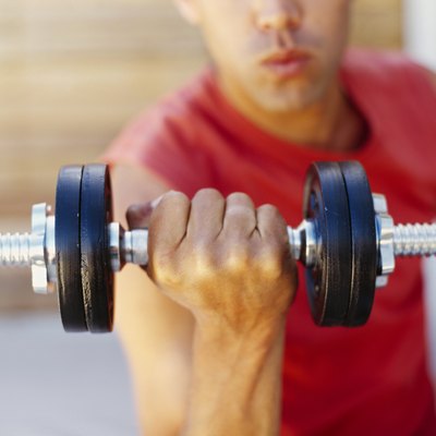 close-up of a young man exercising with a dumbbell