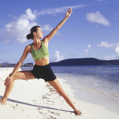 Woman doing yoga on beach