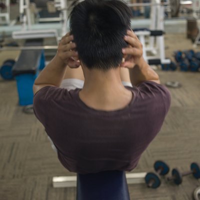 Young man exercising doing sit-ups indoors for diet